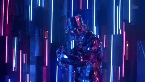 A-glass-man-reflecting-light-dances-against-a-neon-wall-with-purple-and-blue.